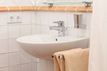 White traditional sink with towels of bathroom