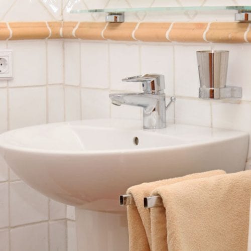 White traditional sink with towels of bathroom
