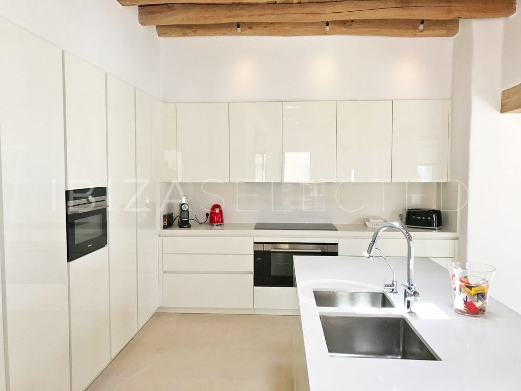 white shiny kitchen with sink in kitchen center