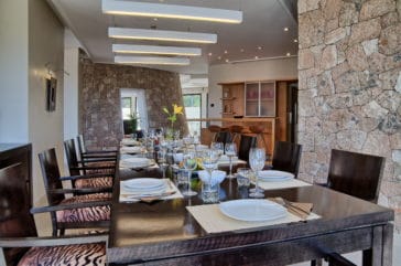 Inner dining area with laid table and walls in stone design