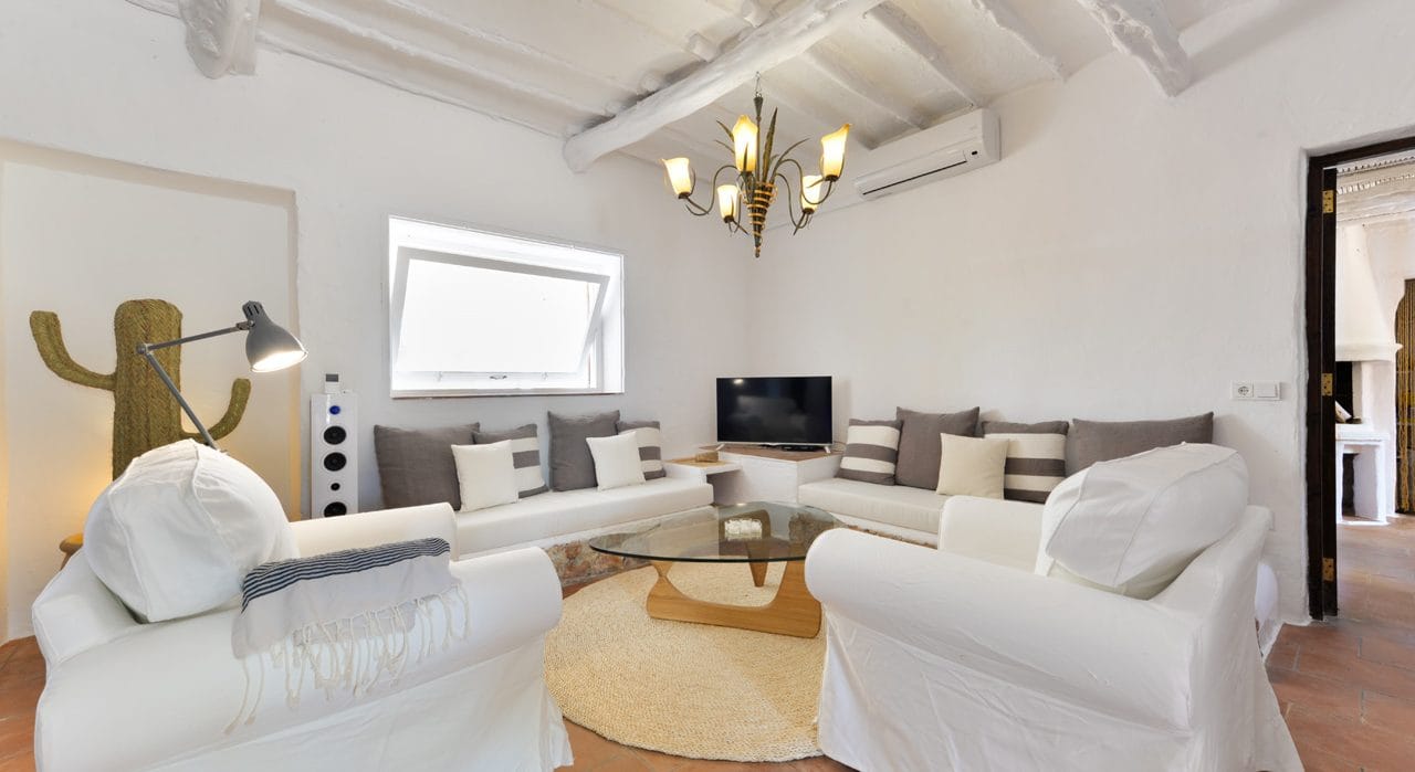 Inner lounge suite in rustic style with glass couch table and sound system