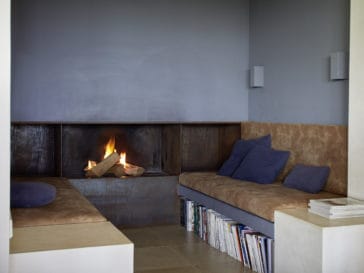 Crackling fire at the fireplace with sofas