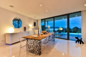 Illuminated dining area with look to the pool