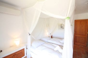 Bedroom with large romantic mosquito net