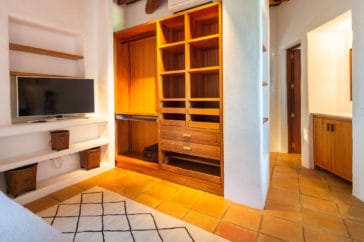 Bedroom's wooden cupboard and access to open en-suite bathroom