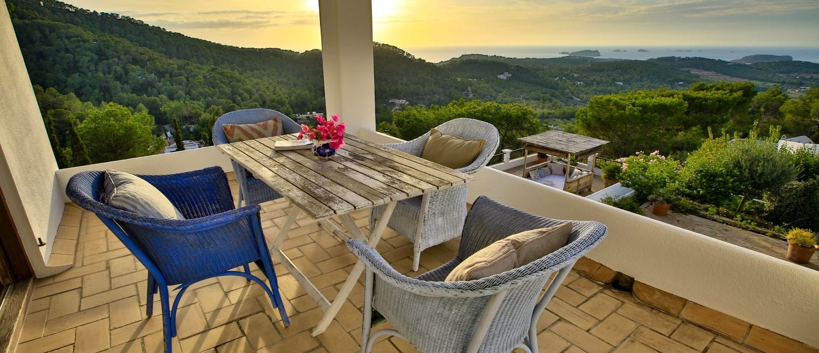 Seat group on covered roof terrace with sunset view