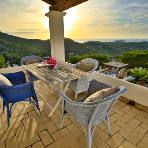 Seat group on covered roof terrace with sunset view