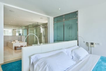 Master Bedroom's double bed in front of spacious modern open en-suite bathroom