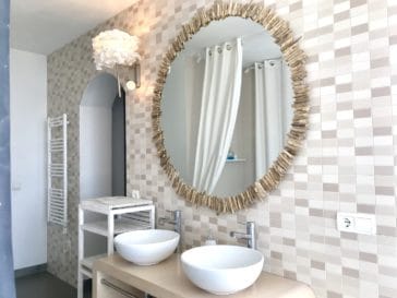 Bathroom with 2 round sinks and mirrow