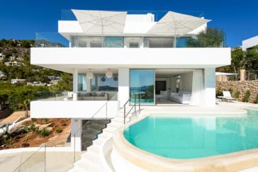 Front view of villa on 3 floors and terraces on each with stairs from ground floor up to pool on second floor