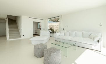 White lounge suite of living room beside kitchen room