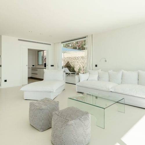 White lounge suite of living room beside kitchen room