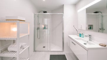 White bathroom with walk-in shower and one washbasin