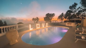 Illuminated pool with illuminated letters LOVE