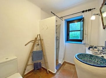 Bathroom with shower and a rustic oriental round sink