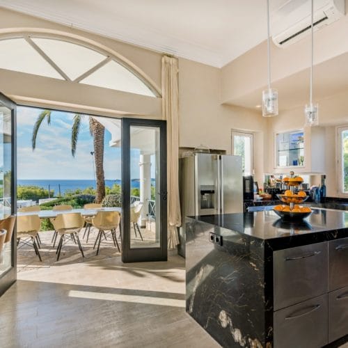 Modern stainless steal and polished chrome kitchen with access to outside dining area