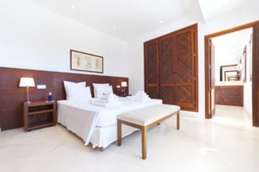 Natural wooden furnished bedroom with en-suite bathroom