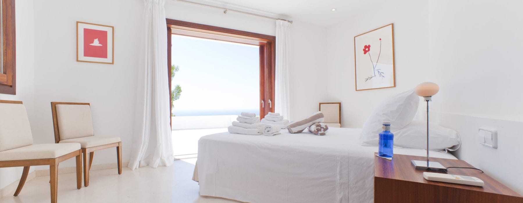 Double bedroom in white and wooden design with access to sea view terrace