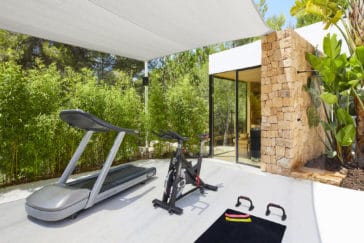 Outdoor gym area with spinning bike and treadmill
