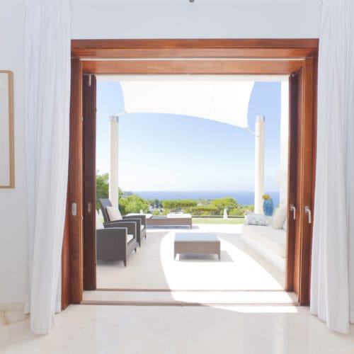 Access through wooden framed double door to the veranda with sea views