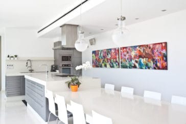 Modern open kitchen with kitchen centre and adjoining dining table