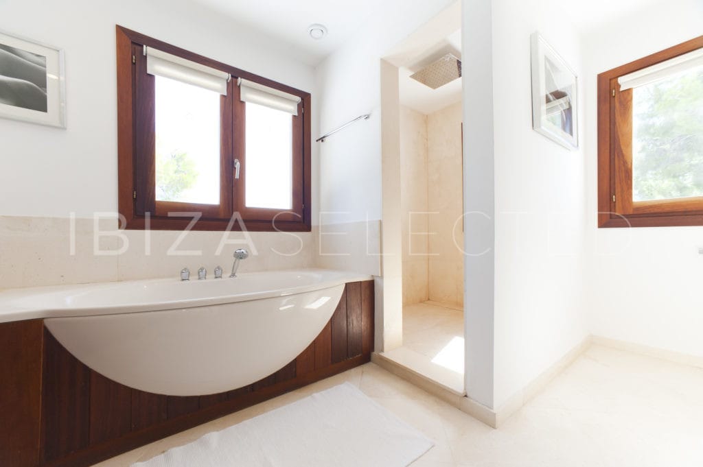 Bathroom with modern wooden style bathtub and corner shower
