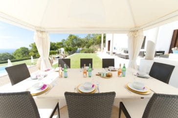 Outdoor laid dining area covered with a tent roof