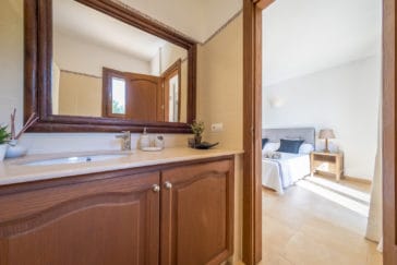 En-suite bathroom with one sink vanity and toilet in wooden design