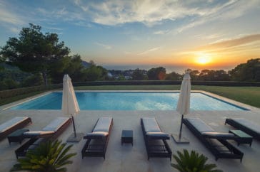Sunset sea view overlooking the pool terrace and lawn garden