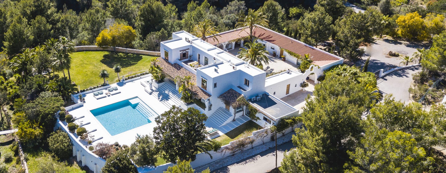Bird's eye view of whole villa with spacious patio and pool located on a hill