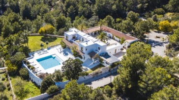 Bird's eye view of whole villa with spacious patio and pool located on a hill