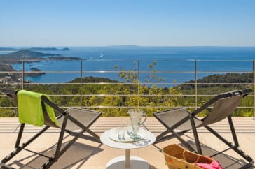 2 sun chairs on an open air terrace looking to west cost sea of Ibiza island