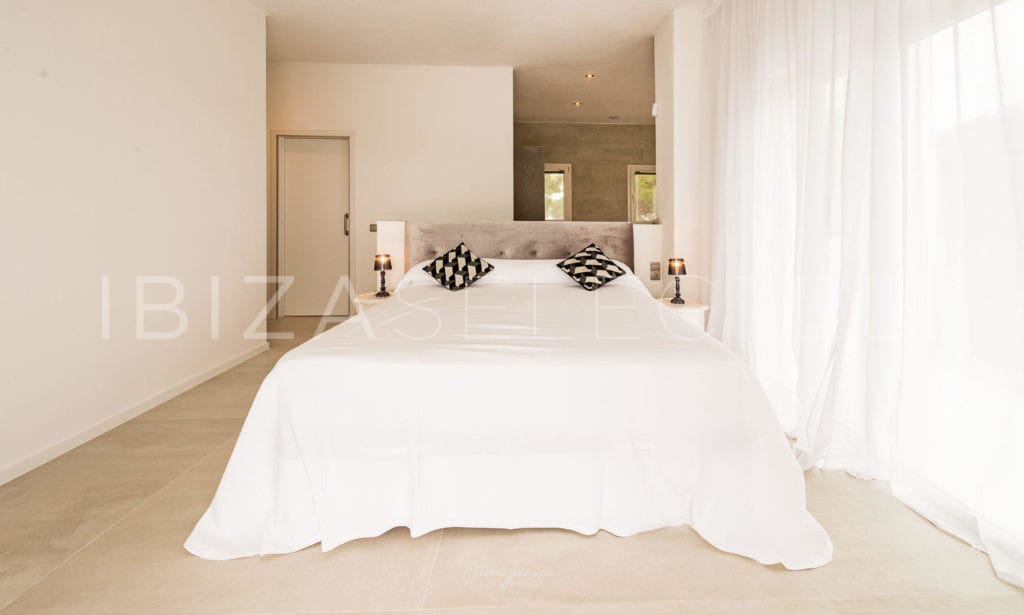 Double bedroom with huge door window with white curtain