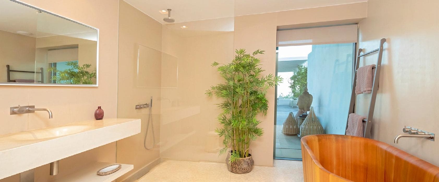 Spacious modern bathroom with walk-in shower and round wooden bathtub