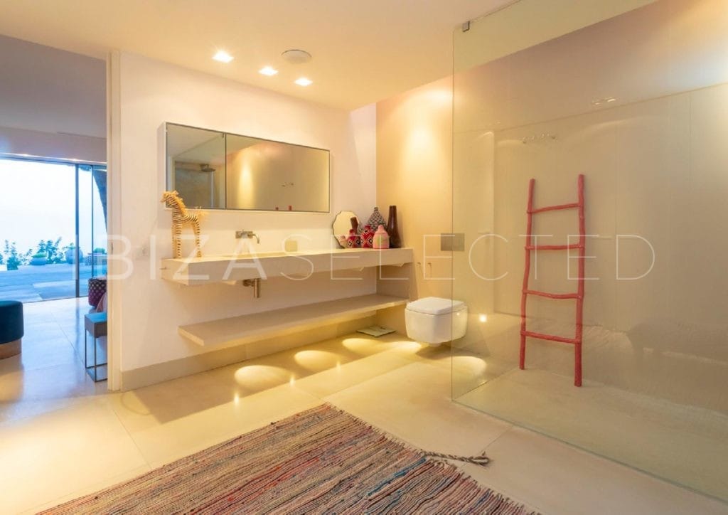 Modern bathroom with walk-in shower, hanging toilet and one sink vanity