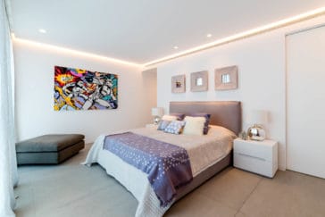 Modern double bedroom with pop-art painting on the wall