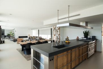 Modern kitchen centre in wooden, dark grey and chrome metal colours