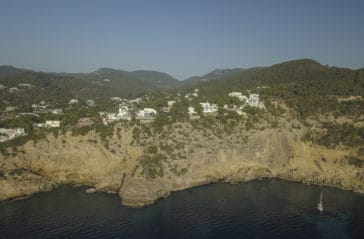View of Cala Moli bay with high rocks