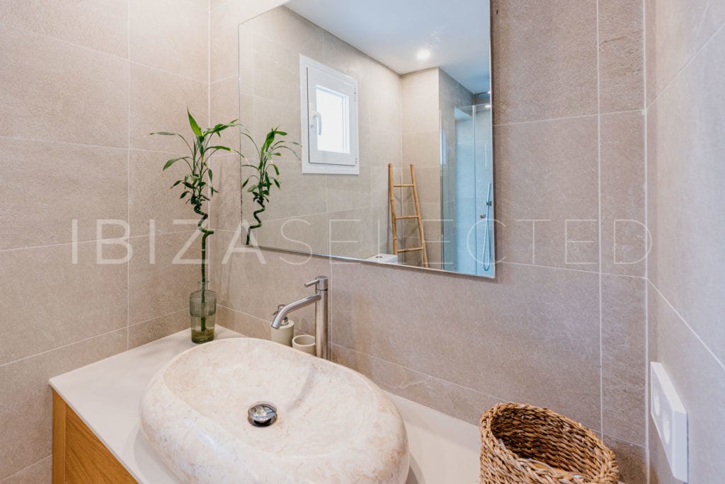 Bathroom with modern round stone wash-basin