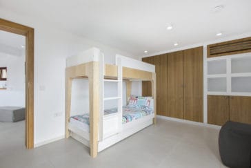 Room with children's loft bed and wooden wardrobe