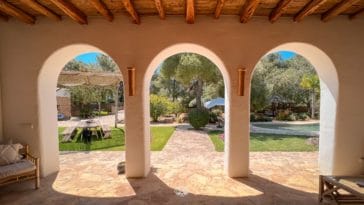 Look to pool from roofed veranda's round arches