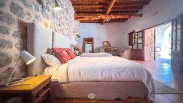 Rustic bedroom with 2 big twin beds and access to veranda