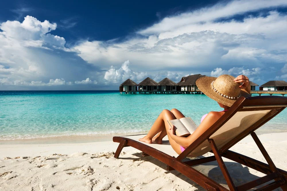 Young Woman Reading A Book At The Beach 1