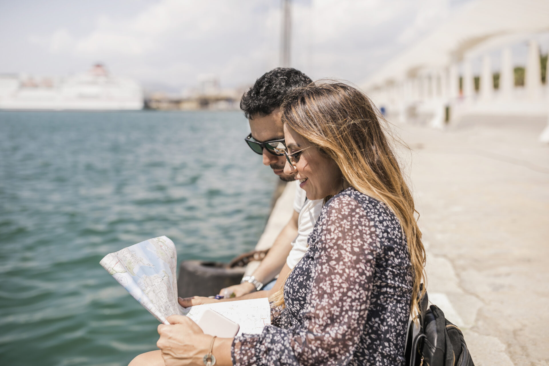Smiling Tourist Couple Sitting Jetty Looking Map